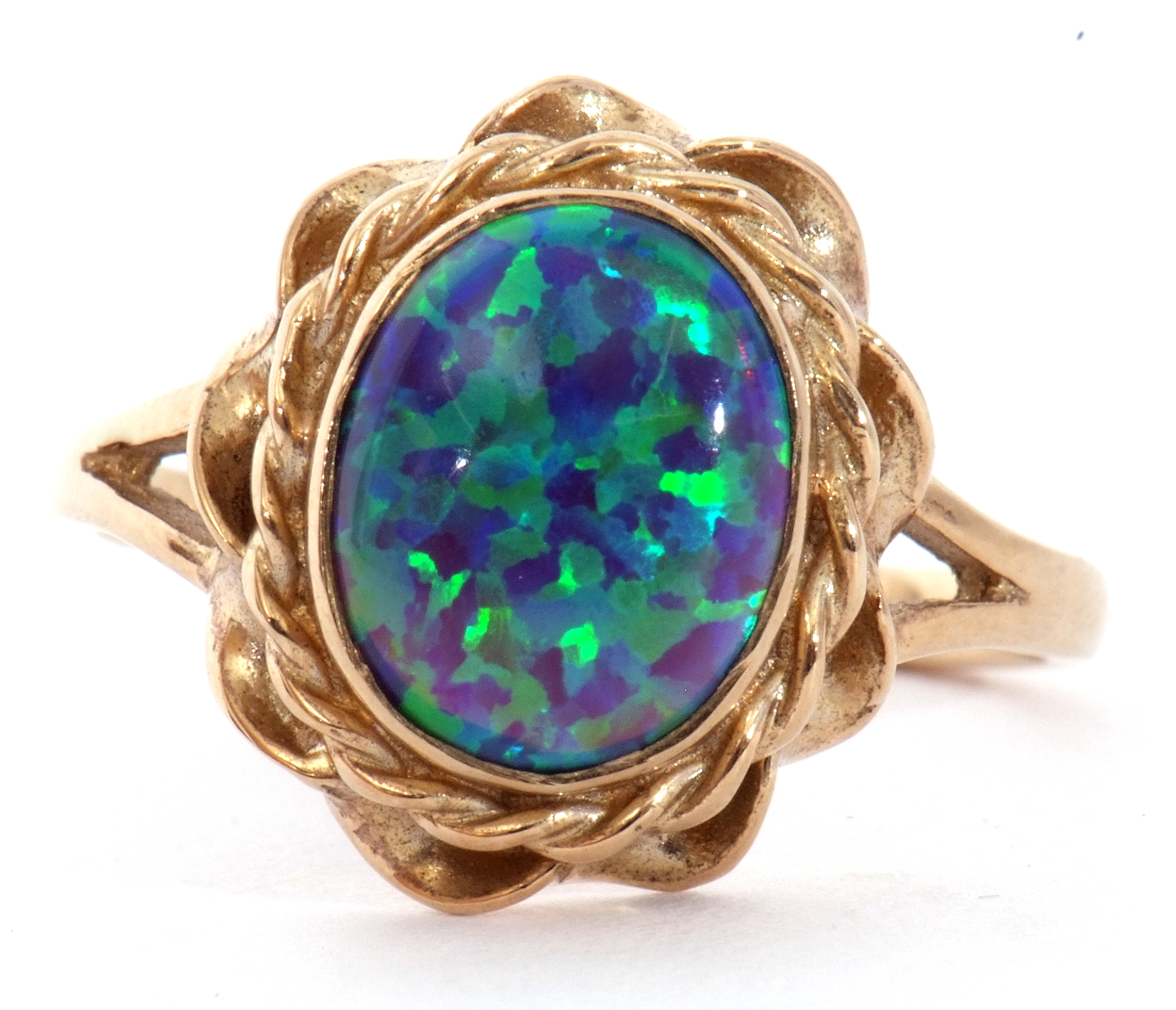 Modern 9ct gold and opalescent ring, the oval cabochon bezel set in a rope twist and pierced