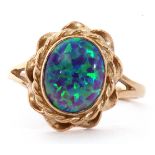 Modern 9ct gold and opalescent ring, the oval cabochon bezel set in a rope twist and pierced