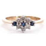 Modern diamond and sapphire cluster ring featuring five small diamonds and three small sapphires,