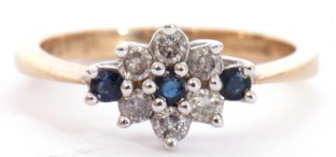 Modern diamond and sapphire cluster ring featuring five small diamonds and three small sapphires,