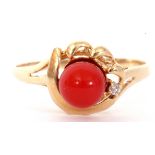 Vintage coral bead and small diamond set ring, the coral bead raised between pierced scroll and