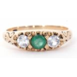 Modern 9ct gold paste set ring centring a green coloured stone between two pastes