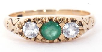 Modern 9ct gold paste set ring centring a green coloured stone between two pastes
