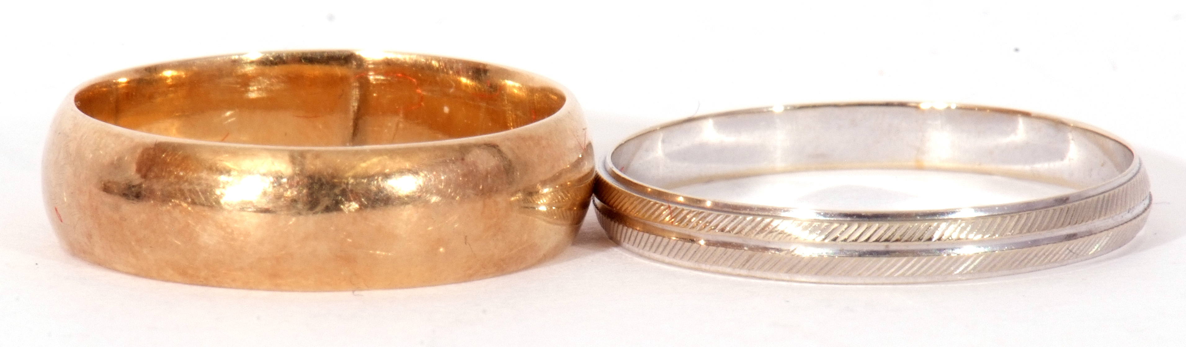 Mixed Lot: Two precious metal wedding ring, both stamped 585, a wide yellow plain polished ring