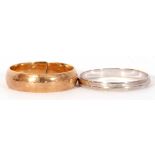 Mixed Lot: Two precious metal wedding ring, both stamped 585, a wide yellow plain polished ring