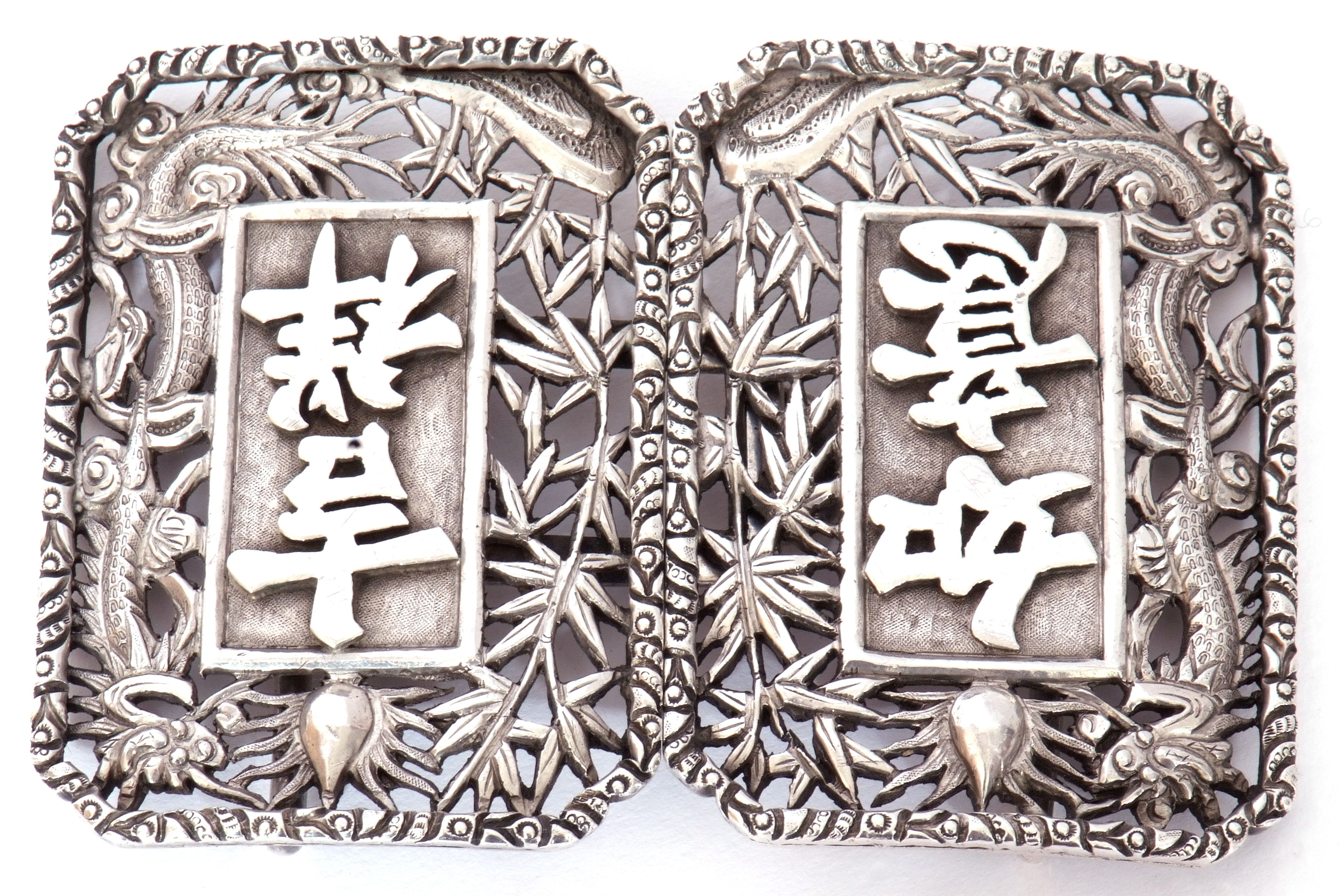 Early 20th century Chinese export two-part white metal belt buckle, featuring two ornately