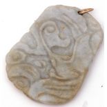 Antique carved jade pendant of shaped rectangular flat form, deep carved with naturalistic detail