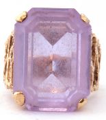 Modern large light purple stone dress ring, featuring a stepped cut purple stone, four claw set