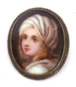 Vintage porcelain painted oval brooch depicting a head and shoulders portrait of a young lady,