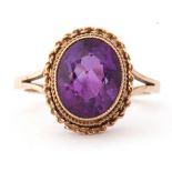 Modern 9ct gold and amethyst ring, the oval faceted amethyst bezel and milliegrain set with a rope