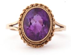 Modern 9ct gold and amethyst ring, the oval faceted amethyst bezel and milliegrain set with a rope