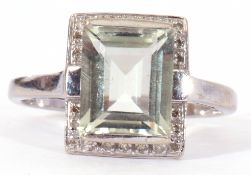 9ct gold and pale blue stone and diamond set ring, the step cut stone raised with a small diamond