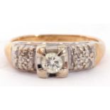 750 stamped diamond ring centring a round brilliant cut diamond, 0.20ct approx, raised above diamond