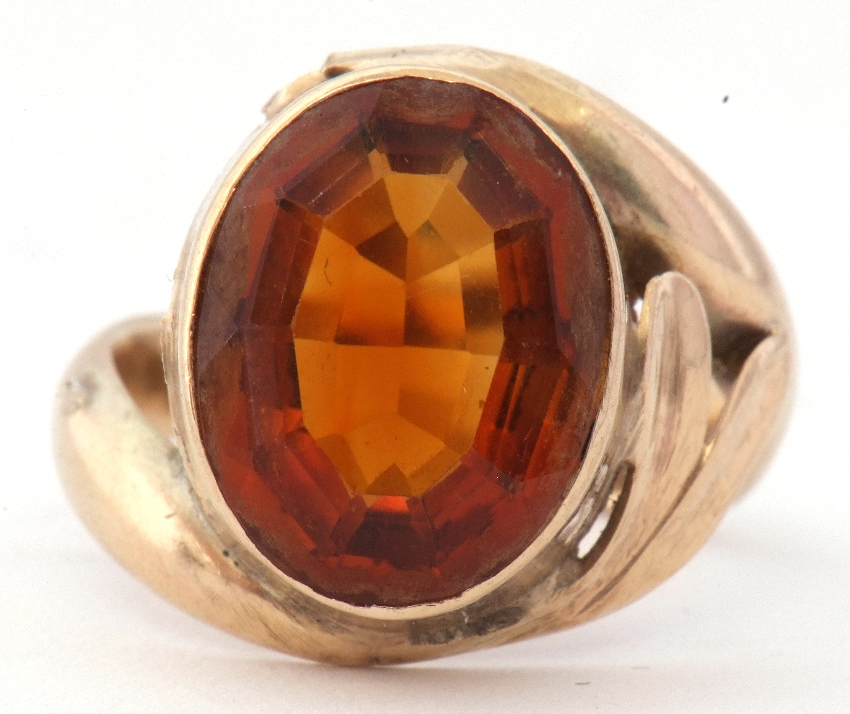 9ct stamped cognac citrine dress ring, the oval faceted citrine in a rub-over setting raised between