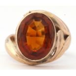 9ct stamped cognac citrine dress ring, the oval faceted citrine in a rub-over setting raised between