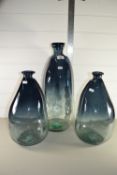 THREE GREEN TINTED GLASS BOTTLES