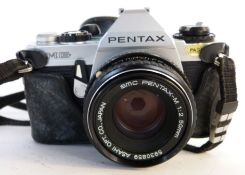 Pentax MG film camera together with a Pentax-M 50mm lens and manual