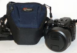 Fujifilm Finepix S100 FS digital camera, together with Fujinon zoom lens, 7.1 x 101.5mm lens in