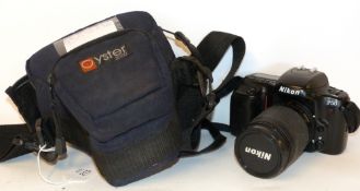 Nikon F50 film camera together with Nikon AF Nikkor 28-80mm lens in fitted case
