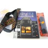 Digital SLR handbook by Michael Freeman, plus a lens cleaning kit and spare straps