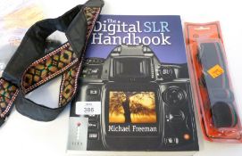Digital SLR handbook by Michael Freeman, plus a lens cleaning kit and spare straps