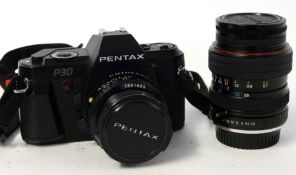 Pentax P30 film camera together with a Pentax-A 50mm lens + Tokina 28-70mm lens and manual