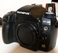 Olympus Zuiko digital 12-60mm, 1:2.8-4 lens together with Olympus E-30 digital camera, charger and