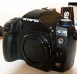 Olympus Zuiko digital 12-60mm, 1:2.8-4 lens together with Olympus E-30 digital camera, charger and