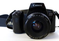Canon EOS 1000F film camera together with Canon zoom lens EF35-80mm