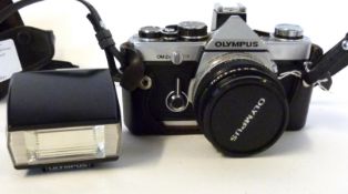 Olympus OM-2 film camera together with Zuiko 50mm lens with flash and case
