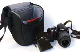 Nikon D3100 digital camera together with Nikon AF-S DX Nikkor 18-55mm lens, charger and fitted case