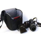 Nikon D3100 digital camera together with Nikon AF-S DX Nikkor 18-55mm lens, charger and fitted case