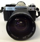 Canon AE-1 film camera together with Vivitar 28-200mm lens