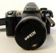 Nikon F80 film camera with film already loaded, together with Nikon AF Nikkor 28-100mm lens