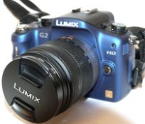 Lumix G2 digital camera together with Lumix 14-42mm lens, charger and fitted case