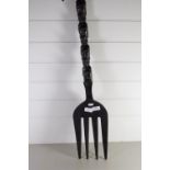 LARGE WOODEN FORK MODELLED AS A TOTEM POLE WITH CARVED HEADS