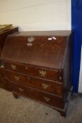 19TH CENTURY FALL FRONT OAK BUREAU RAISED ON BRACKET FEET WITH LATER MOUNTED SILVER INSCRIPTION