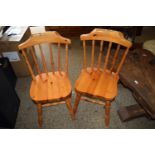 TWO MODERN VARNISHED PINE KITCHEN CHAIRS