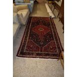 LARGE RUG WITH STYLISED FLORAL DESIGN AROUND CENTRAL GEOMETRIC PANEL
