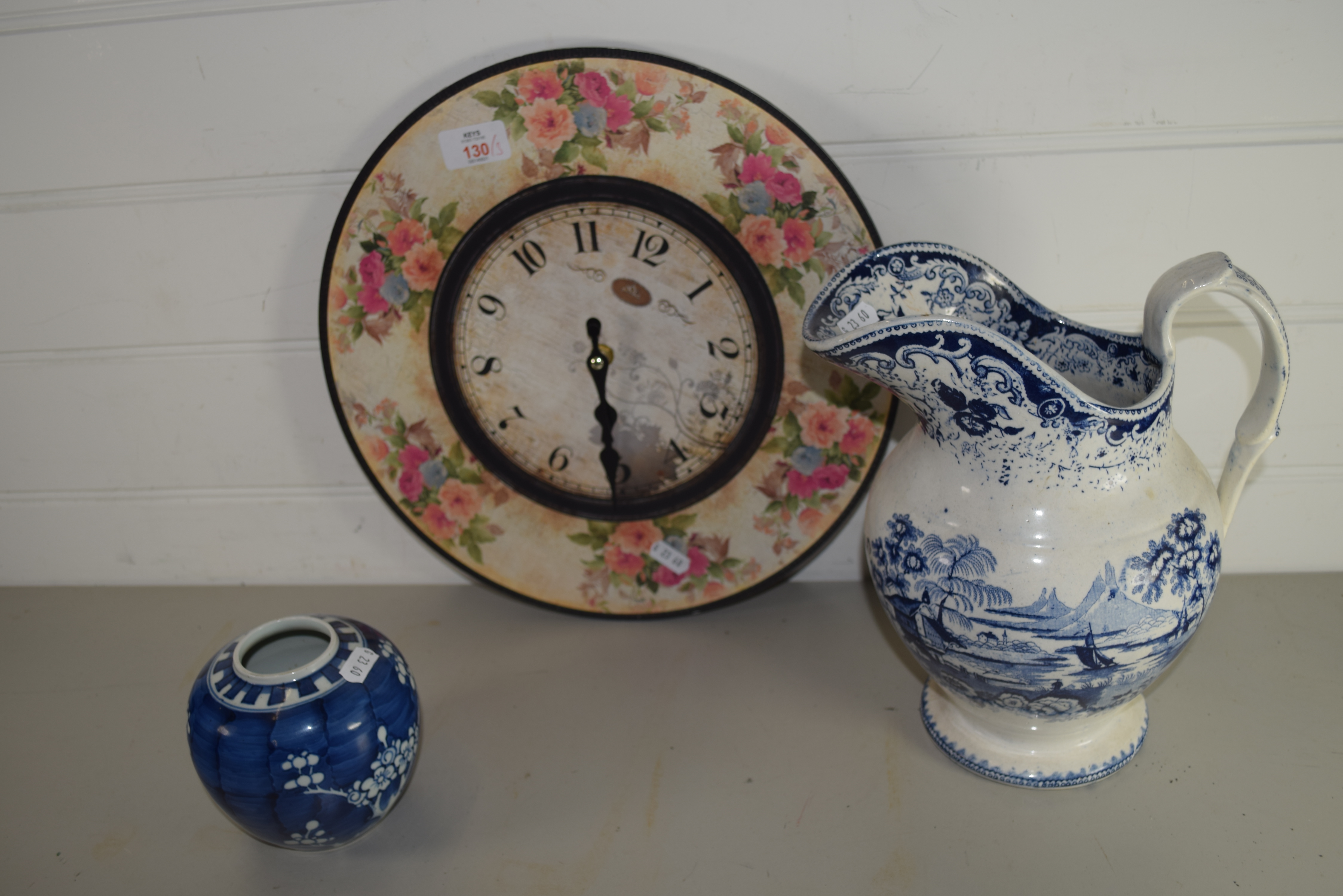 WALL CLOCK WITH BLUE AND WHITE JUG AND FURTHER SMALL JAR WITH PRUNUS DECORATION