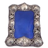 Late Victorian silver photograph frame with pierced and embossed border, decorated with cherubs,
