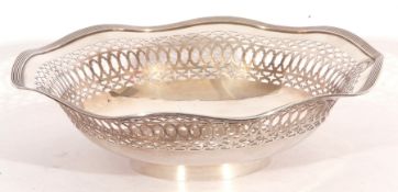 George V silver dish having pierced sides and reeded wavy rim and raised on a circular foot,