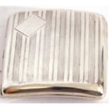 George V silver cigarette case of shaped square form, with engine turned decoration back and