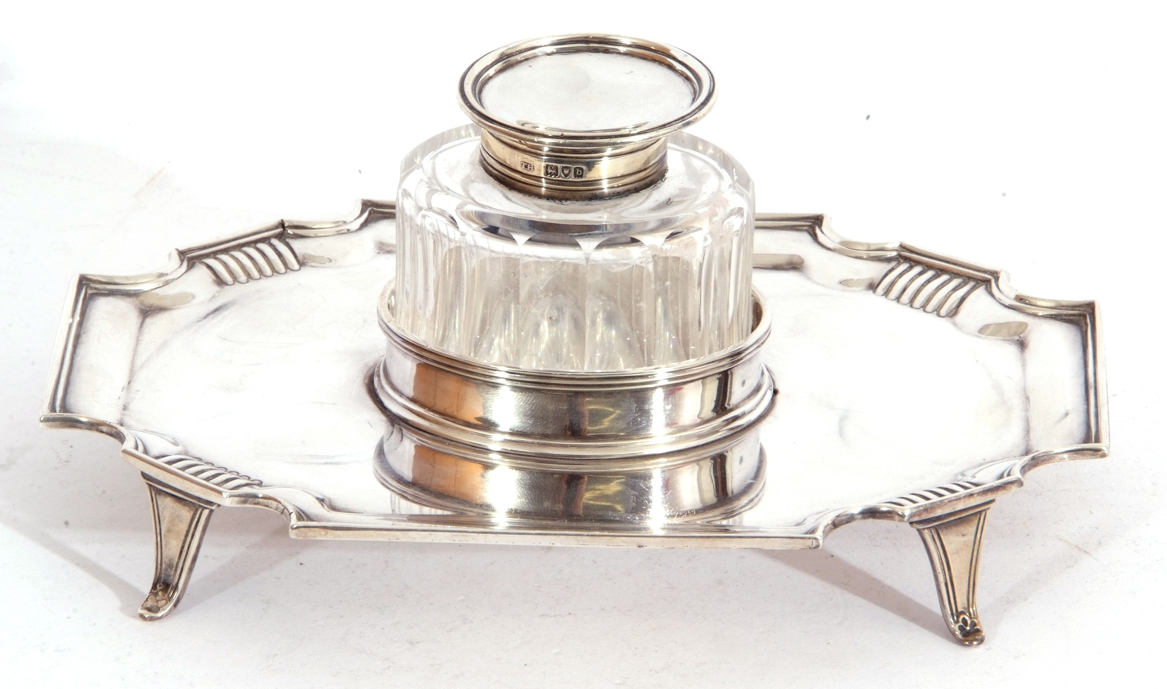 Late Victorian silver ink stand of shaped rectangular form resting on four splayed feet with