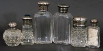 Collection of six glass scent bottles/jars, three with hallmarked silver screw on lids, one silver