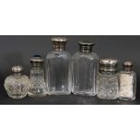 Collection of six glass scent bottles/jars, three with hallmarked silver screw on lids, one silver