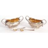 Cased pair of late Victorian silver open salts and matching spoons, boat shaped with fluted bodies