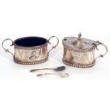 George V silver mustard of oval form with domed hinged lid and urn finial, gadrooned borders,