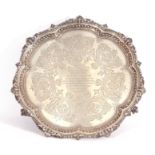 Victorian silver salver of shaped circular form with shell and bead border, central presentation