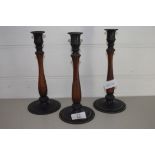 THREE WOODEN CANDLESTICKS WITH METAL SCONCES